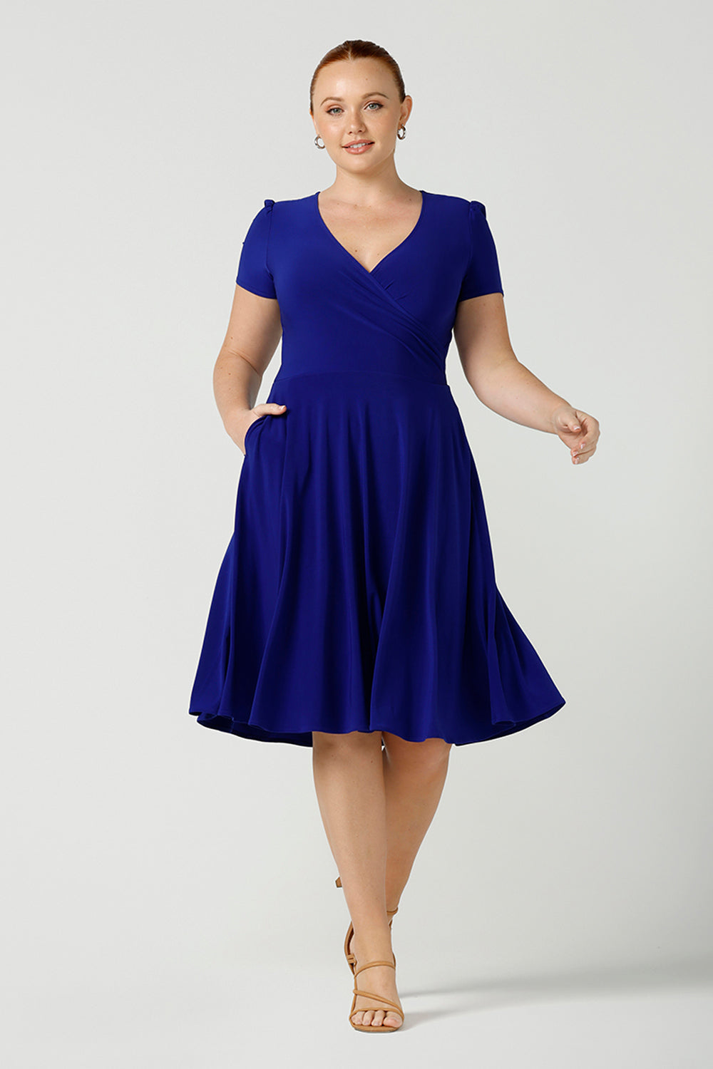  A size 12, fuller figure woman wears a jersey dress with short sleeves. In cobalt blue jersey, this dress is a good casual dress for weekend wear capsule wardrobes. Shop Australian-made dresses online is sizes 8 to 24.