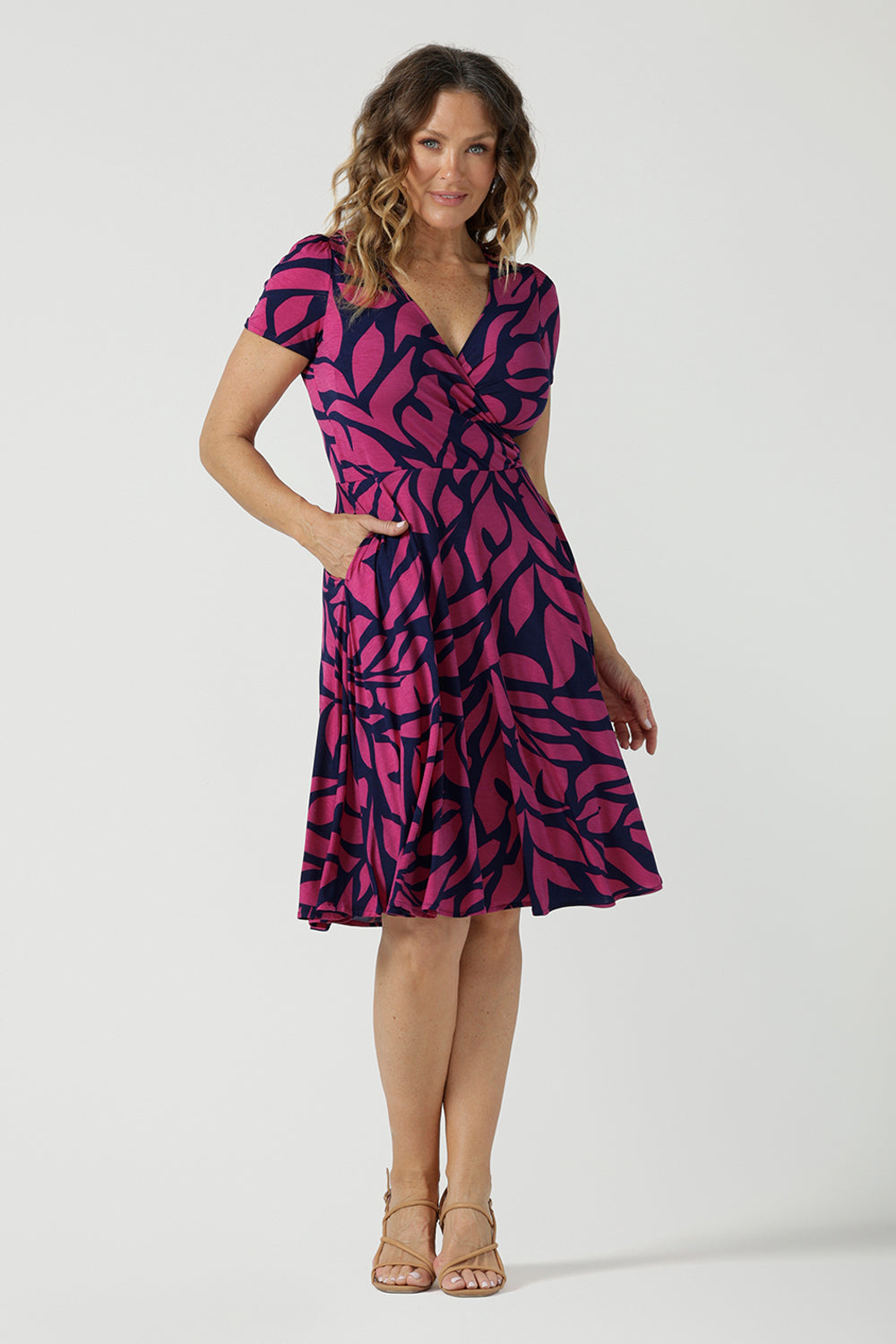 Bibi Fixed Wrap Dress in Pink Jungle. A pink and navy abstract print dress made in comfortable jersey fabric. Just below knee length with short sleeves. A v-neeckline. Designed for petite to plus size women -24. Designed and made in Australia. 