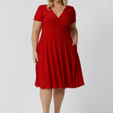 This elegant knee-length dress is crafted from a luxurious dry touch jersey fabric, perfect for the festive season. Featuring a vibrant red hue, it captures the essence of the season beautifully. Made in Australia, this dress is designed for women and is available in sizes 8 to 24, ensuring a flattering fit for all. Whether you're attending holiday gatherings or celebrating special moments, this dress combines style and comfort effortlessly.