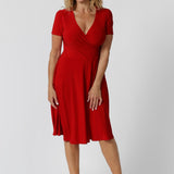 Over 40 year old woman wearing a red knee length dress, made of fabric that is cooling dry touch jersey. Capturing the essence of the festive season, this sleeved dress is designed for the warmer weather and upcoming occasions. Available in sizes 8 to 24. Leina & Fleur ensure that there is a flattering fit for all.