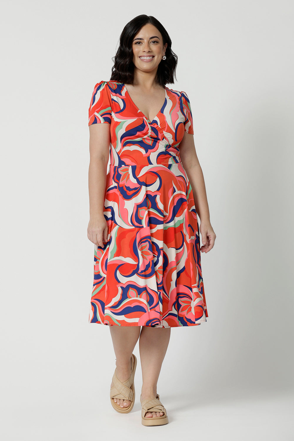 The best fixed wrap dress for petite height women, the Bibi Wrap Dress is new in Tangerine, Red, White, Mint Green and Purple retro print. Shown on a petite woman, this summer wrap dress is a fit and flare style with full, knee length skirt and pockets. Easy-care, it's a good dress for travel and cruise wear. Made in Australia by Australian and New Zealand women's clothes brand Leina & Fleur.