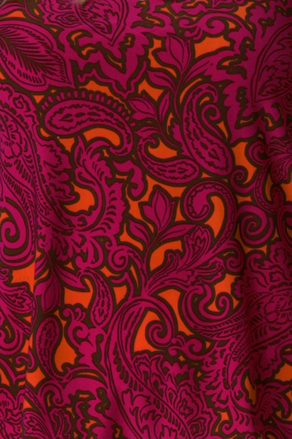 Bold Paisley print is on a soft-touch jersey base with paisley print details in fuchsia pink, orange and black. The fabric has a soft stretch and has been used to create an off duty collection featuring a cami and 2 travel pants.