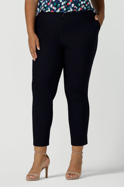 Close up of a curvy size 18 Woman wears Brooklyn pant in Navy. Slim leg trouser pant comfortable corporate wear. Australian made for women size 8 - 24.