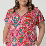 This summer top features short flutter sleeves that add a playful, airy touch, perfect for warm weather. It has a flattering V-neckline with delicate thin ties that can be adjusted for a customisable fit. The fabric showcases a tropical abstract print, bringing a vibrant, exotic feel to the design. Made from lightweight crepe jersey, the material is breathable and comfortable, offering a relaxed fit that drapes beautifully. It's the ideal piece for staying cool and stylish during the summer months.