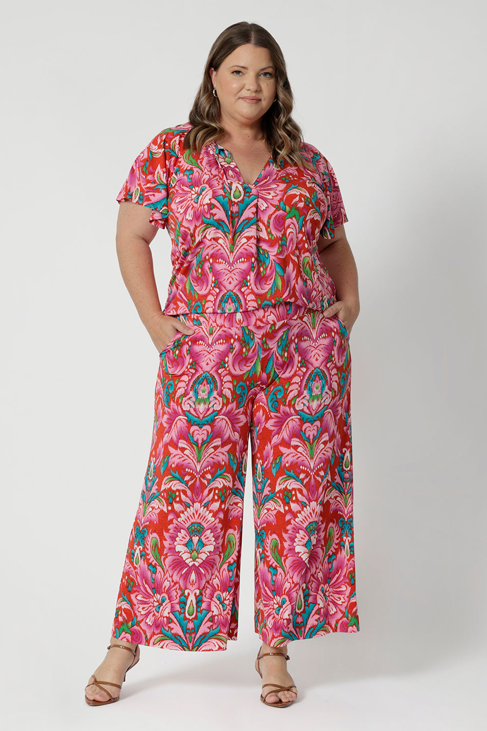 Styling option seen on a plus sized woman. Summer printed flutter sleeved top and matching printed pant to create faux jumpsuit look. Both pieces are stocked in sizes 8-24.