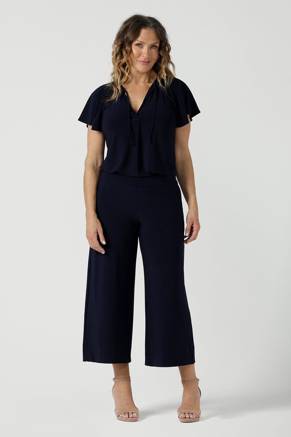 A size 10 woman wears the Bowie Top in Navy made in Australia for women size 8-24,