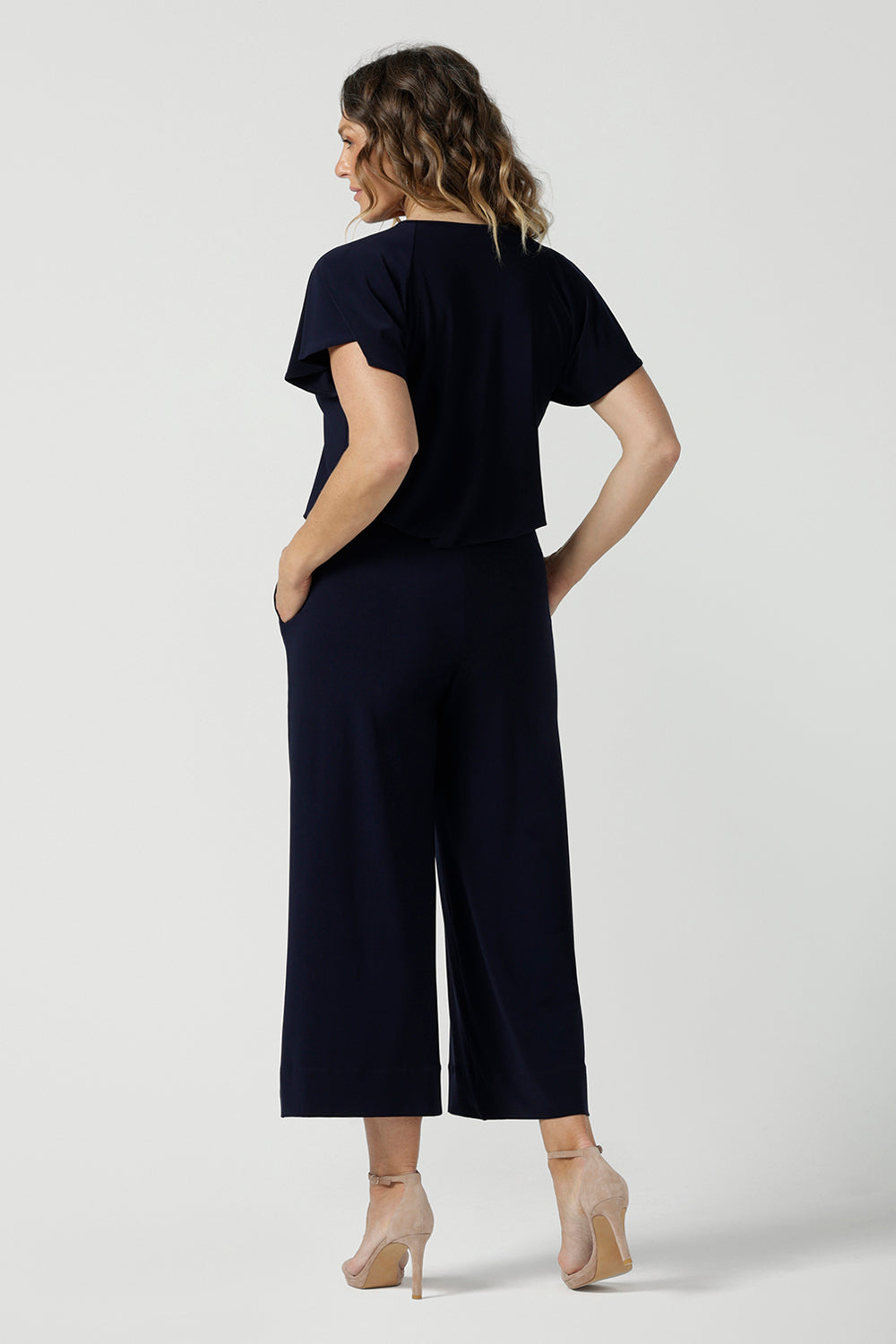 Back view of a size 10 woman wears the Bowie Top in Navy made in Australia for women size 8-24,