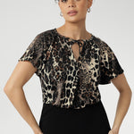 The Bowie Top features a flattering V-neckline with delicate ties that can be worn loose or tied for a vintage-inspired touch. Crafted in our striking Panthera print on a dry-touch jersey, blending black, cream, and brown tones for a bold yet wearable finish.