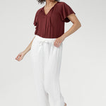 Cool, smooth, and naturally lightweight on the body, it features a relaxed silhouette with a flattering V-neckline and subtle pleat detailing.