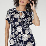 Soft with a silky feel, it features a V-neckline with fine tie accents and a centre-front pleat. The Seashells print showcases a refined marine motif on a navy base. Made in Australia.