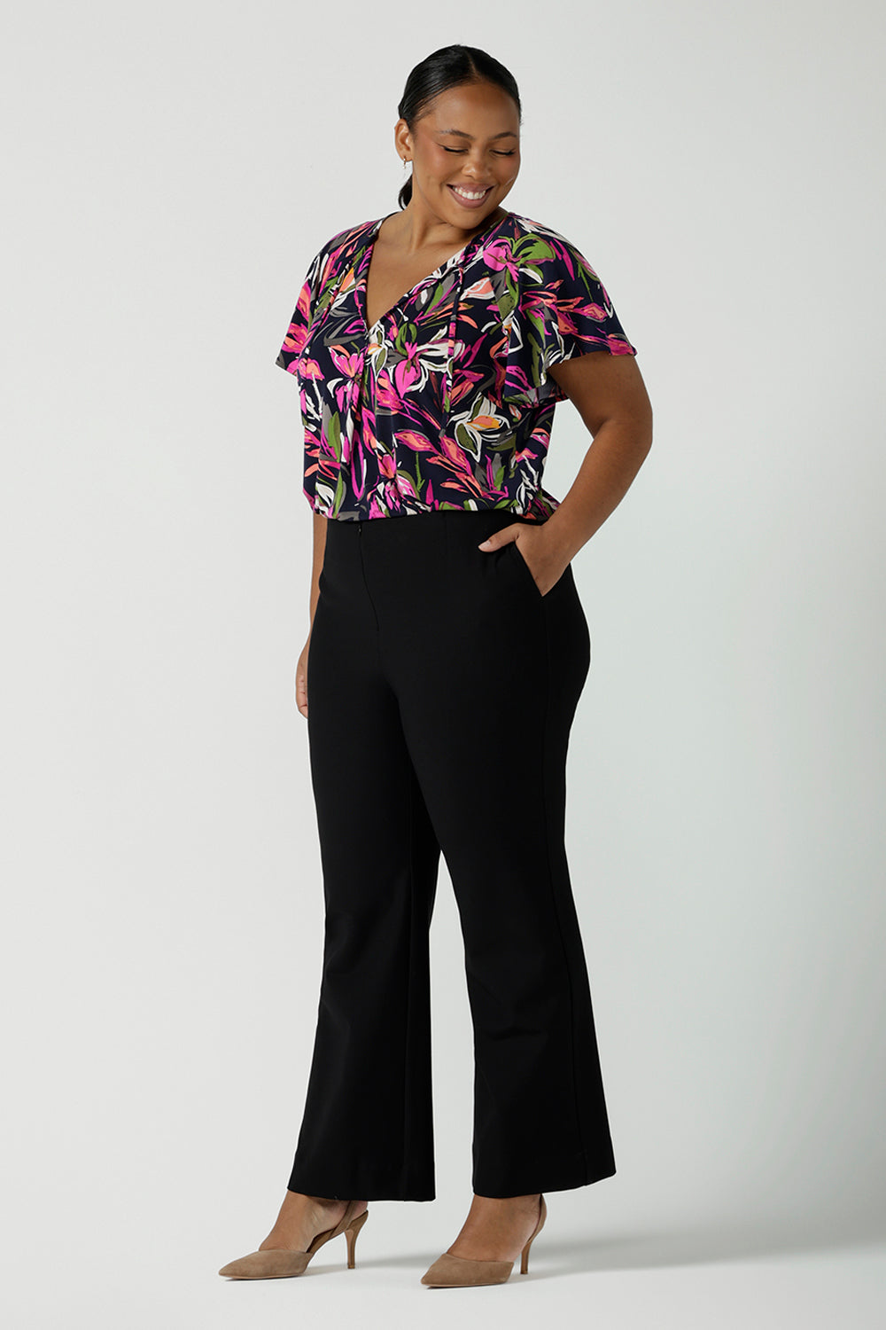 Size 16 Woman wears the Brett Pant in black, a soft tailored ponte jersey pant with a slight kick flare at the bottom. Made in Australia for women size 8 - 24.