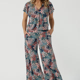 A size 10 woman wears the Bowie Top in jersey with flutter sleeves and tick neckline. Styled back with Denim Pants. Made in Australia for women size 8-24. Styled back with the Presley Pant in Whimsy. 