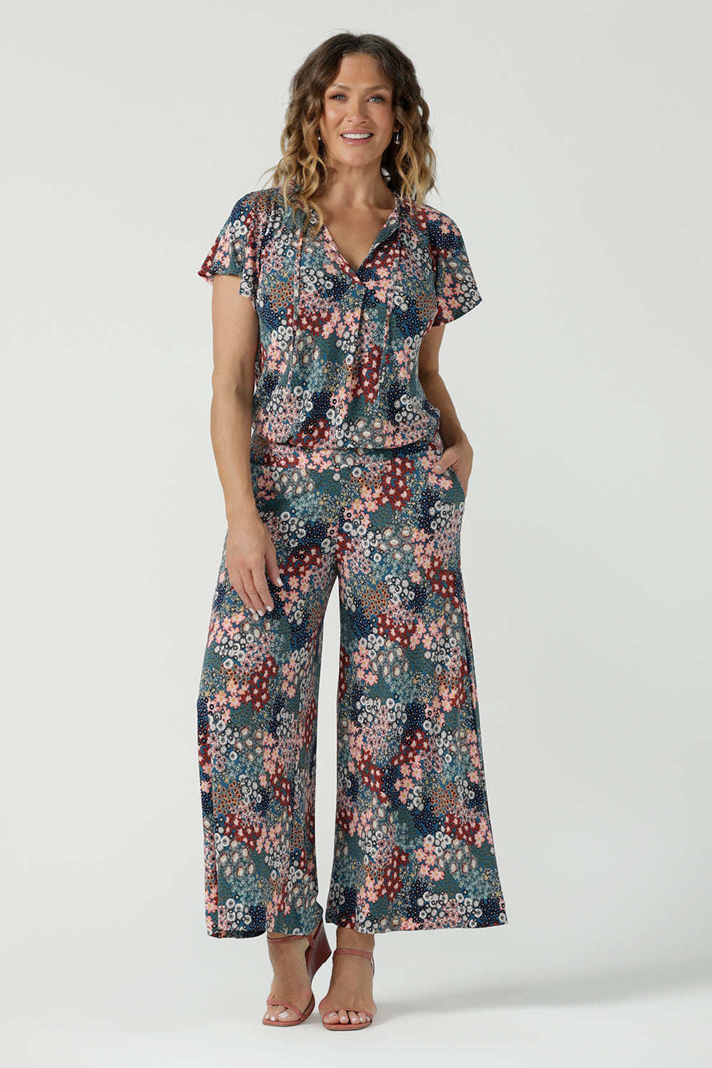 A size 10 woman wears the Presley Pant in Whimsy, a wide leg pant with a Whimsy print. A made in Australia wide leg pant with a ditsy floral print print. Size inclusive fashion for women size 8-24