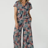 A size 10 woman wears the Presley Pant in Whimsy, a wide leg pant with a Whimsy print. A made in Australia wide leg pant with a ditsy floral print print. Size inclusive fashion for women size 8-24