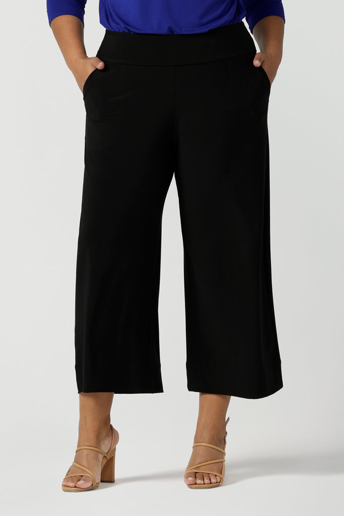 Comfortable, wide leg black culotte pants are worn by a plus size, size 18 woman. Cropped  pants with pockets, these pull-on trousers are made in Australia by women's clothing brand, Leina & Fleur - size inclusive, shop online in petite, mid size and plus sizes.