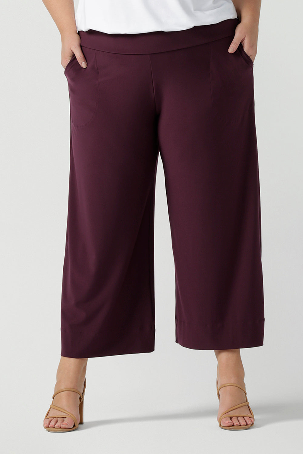Close up of womens stretch work pants. Plus size womens fashion on size 18 in stretch jersey. Size inclusive fashion. Wide leg pant in Mulberry. 