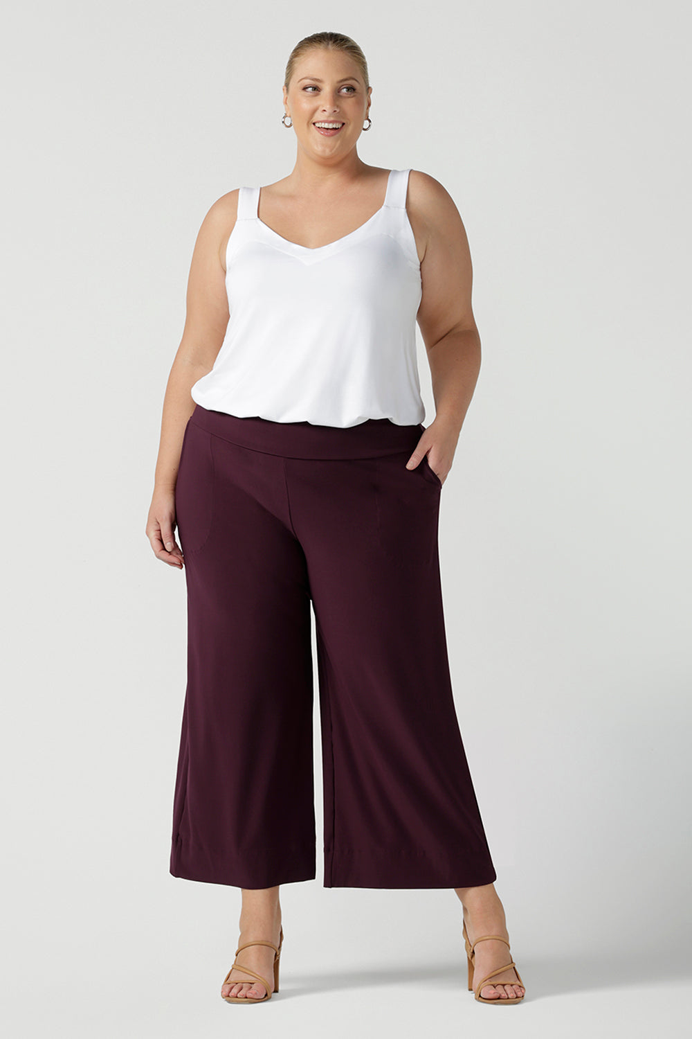 a plus size 18, fuller figure woman wears a bamboo cami. In white bamboo jersey, this top is a good addition to your capsule wardrobe for weekend wear, work and travel. Shop Australian-made dresses online is sizes 8 to 24. Pictured with Mulberry jersey culotte pants. 