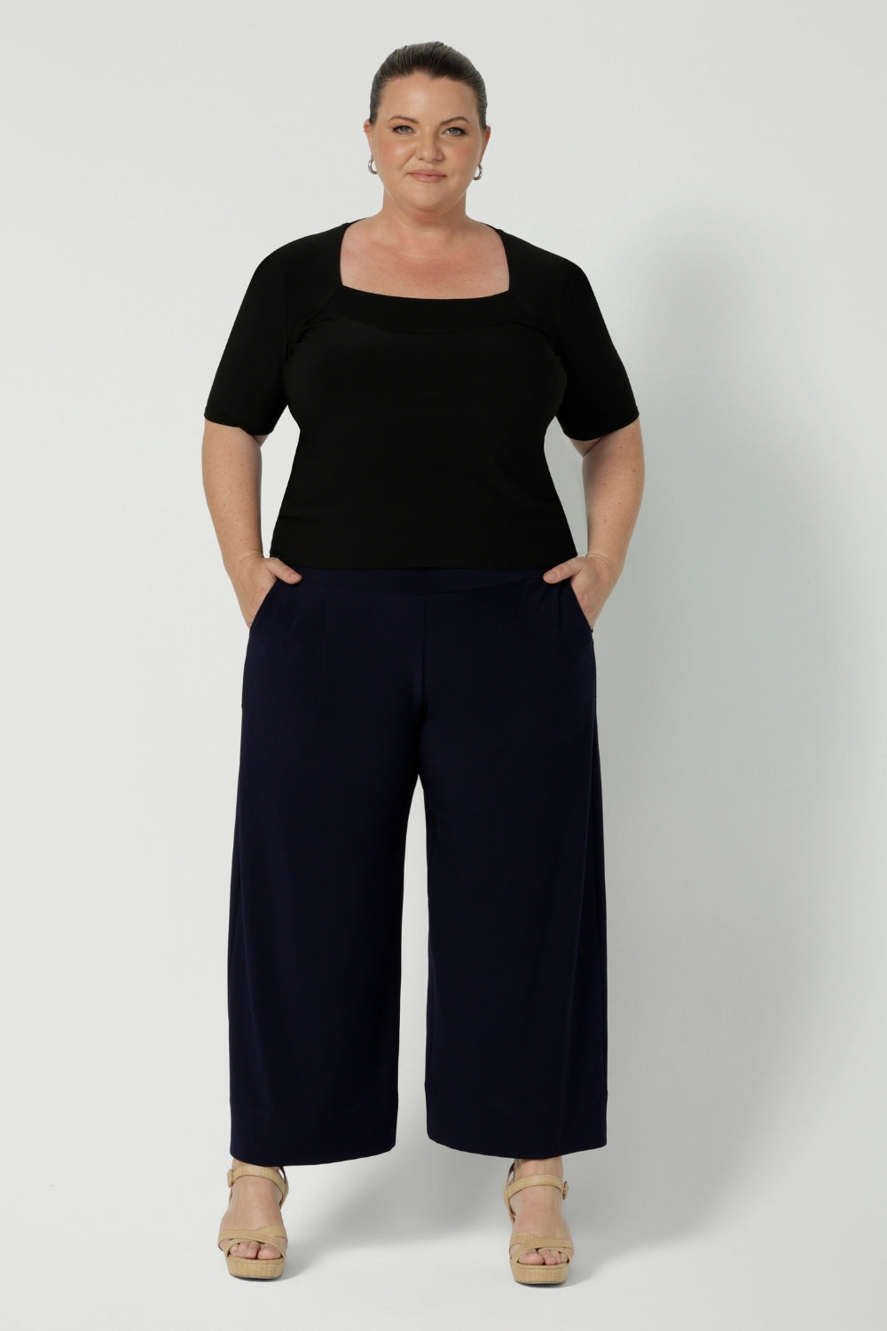 Australian made clothing brand Leina & Fleur have crafted the perfect back to work pant. Plus size woman wears navy wide leg culottes that are now offered in both short & regular lengths. Available in sizes 8-24.