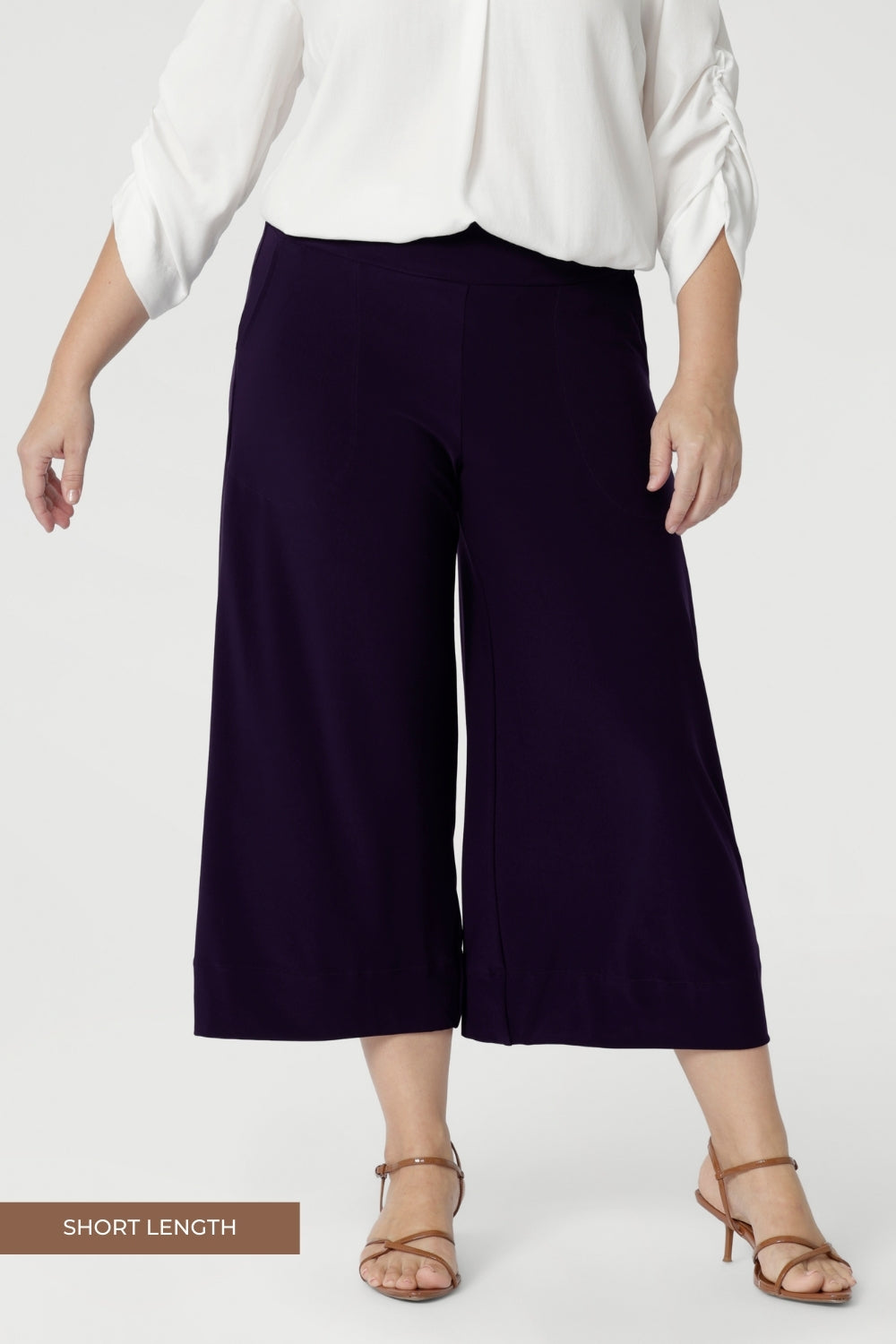 Petite Height Model wears a size 10 in the short length Bradley Culottes. The Bradley Culotte in Purple is the perfect addition to your workwear wardrobe, offering a stylish yet comfortable option for the modern woman. Made from our luxurious jersey base, these culottes drape beautifully. Available in sizes 8-24 and in 2 lengths. 