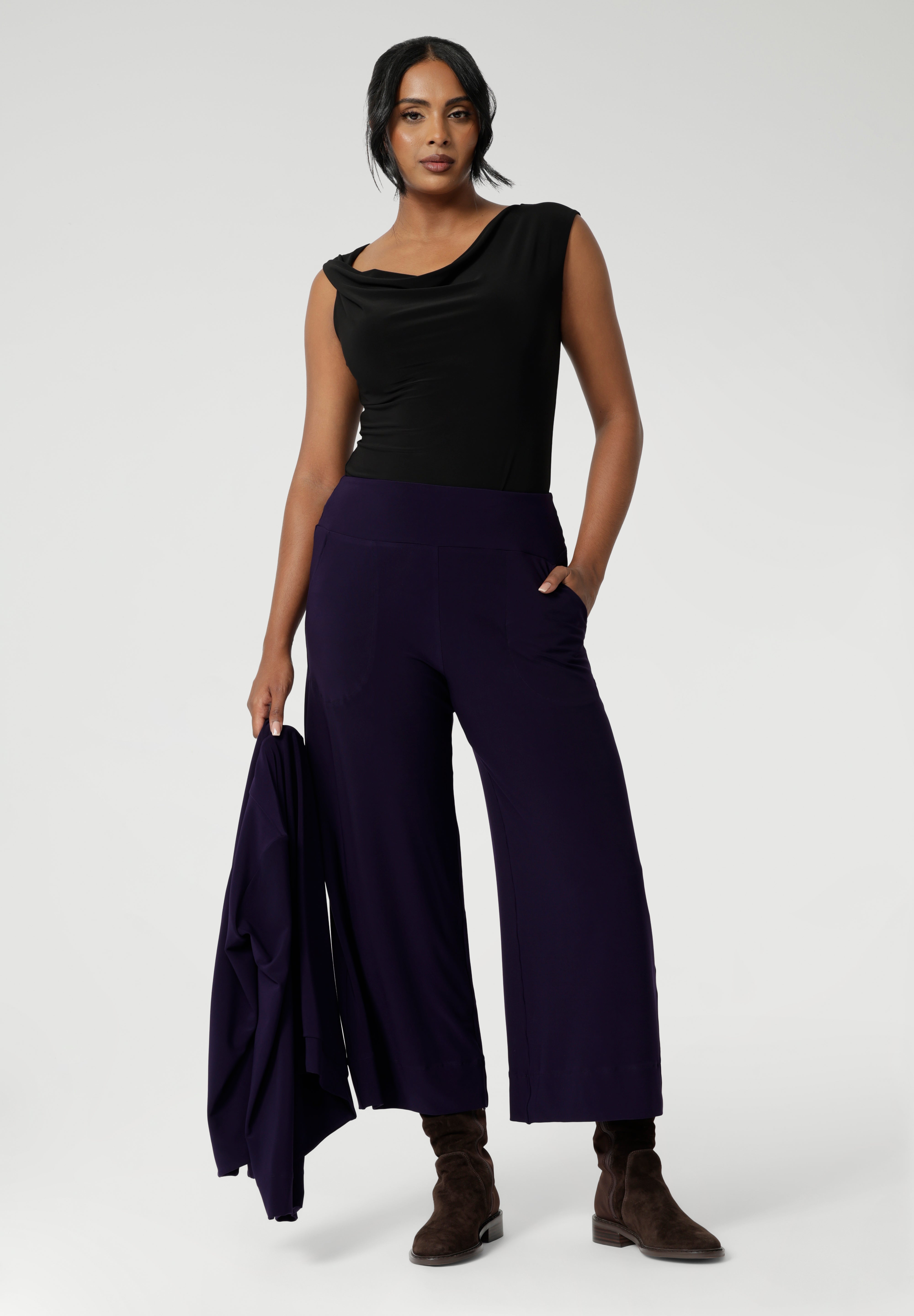 Available in sizes 8-24 and in both regular and short lengths, the Bradley Culotte caters to a variety of body types, ensuring the perfect fit for every woman. Pair them back with the Sandro Jacardi for a soft suiting combination that is both comfortable and chic. Over 30's woman wears culottes with black cowl neck top and matching cardigan. 