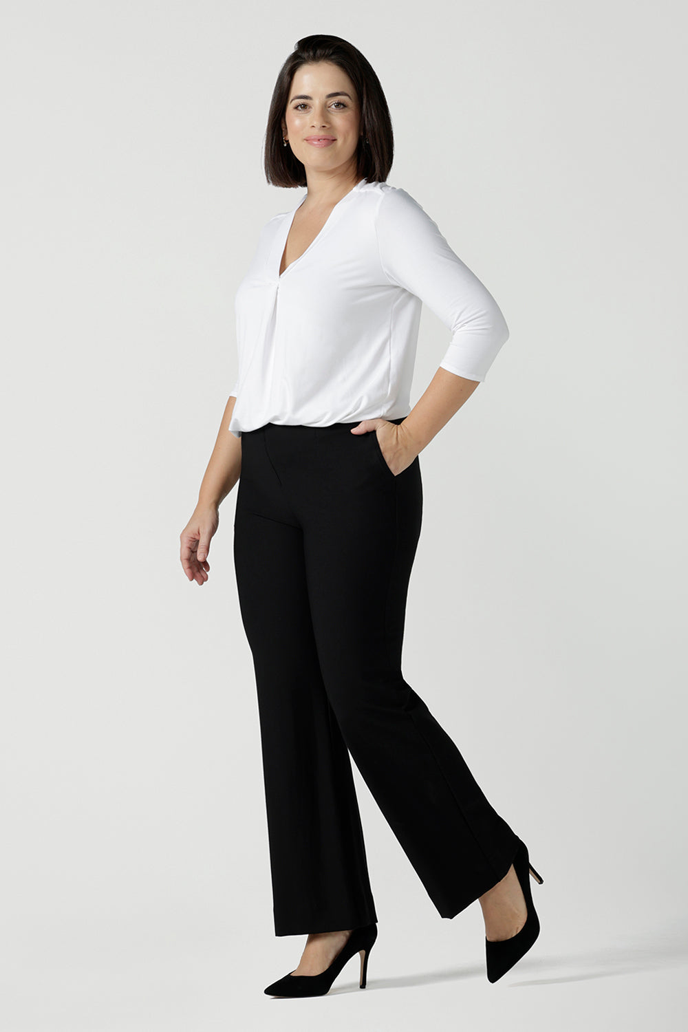 Size 10 woman wears the Brett Pant in black, a tailored work pant with bootleg style leg opening. Great for petite to tall women. Made in Australia pants size 8 - 24. 