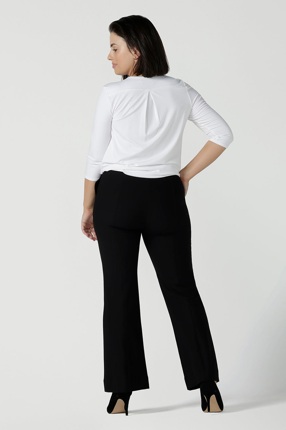 Back view of a size 10 woman wears the Brett Pant in black, a tailored work pant with bootleg style leg opening. Great for petite to tall women. Made in Australia pants size 8 - 24.