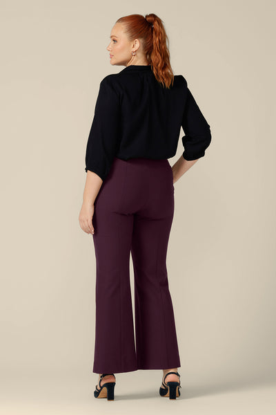 Back view of a good workwear or eveningwear pants, these mulberry trousers by Australia and New Zealand women's clothing label, L&F feature full-length, boot-cut flared legs. Worn with a black shirt as versatile workwear pants.