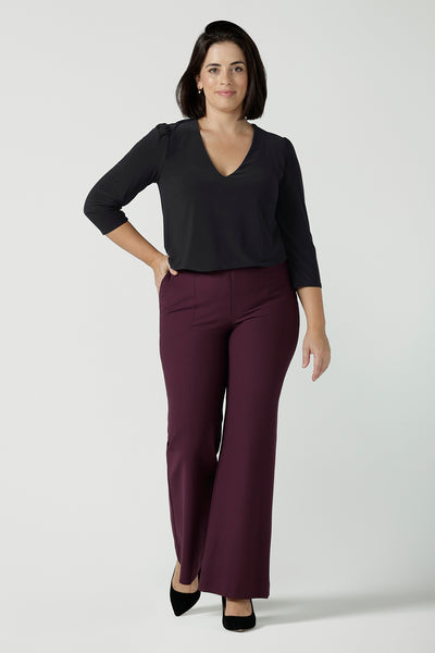 Size 10 model wears the Brett pant in Mulberry a full length pant with a bootleg opening. Constructed in technical stretch ponte with soft tailored details. Invisible fly front zipper side pockets. Suitable for petite to tall heights. Made in Australia for corporate professional women. Size 8 - 24.