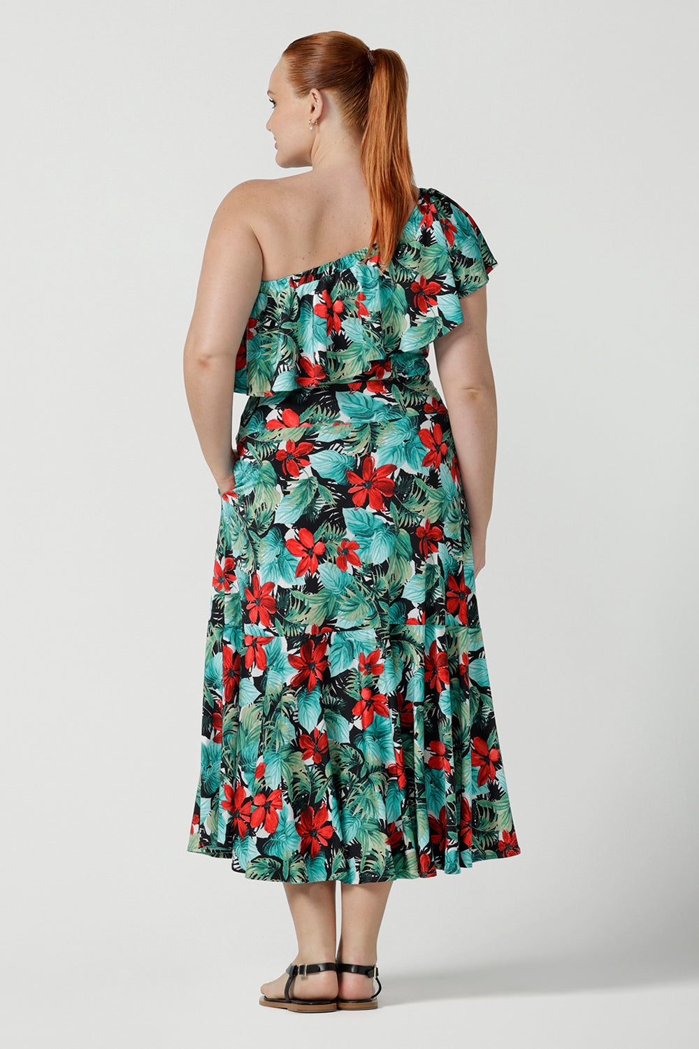 Off shoulder Briar Top in Havana on a size 12 model. Tropical print design with red flowers and green palm leaf. Soft slinky jersey. Wear this top multiple ways one shoulder, off shoulder and on shoulder. Made in Australia for women size 8 - 24.