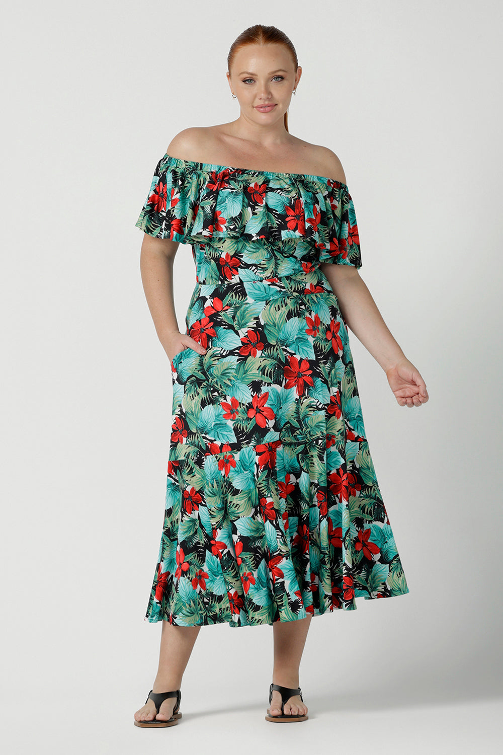 Off shoulder Briar Top in Havana on a size 12 model. Tropical print design with red flowers and green palm leaf. Soft slinky jersey. Wear this top multiple ways one shoulder, off shoulder and on shoulder. Made in Australia for women size 8 - 24.