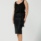 A shimmering jersey neck tie in black puts the finishing touch to an event outfit with a difference. Worn with a black jersey cami top and matching Xanadu skirt, the necktie is used as a belt. Made in Australia by women's clothing and occasionwear brand, L&F.