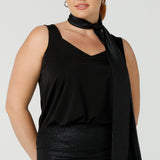 A shimmering jersey neck tie in black puts the finishing touch to a long sleeve, sparkly jersey top for an evening event look. Made in Australia by women's clothing and occasionwear brand, L&F.