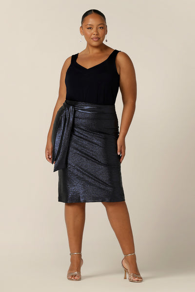 A shimmering jersey neck tie in midnight blue is tied around the waistband of shimmering blue jersey pencil skirt to create a stylish evening and event wear look. Made in Australia by women's clothing and occasionwear brand, L&F.