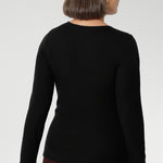 Stay effortlessly stylish through the cooler months with this luxuriously soft knit top, crafted from a premium Tencel wool blend. Designed for comfort and versatility, it features a flattering close-to-body fit that moves with you, thanks to its generous stretch and breathable finish. Black knit top has thumbholes that can be used or tucked away for versatility in styling and extra warmth. 