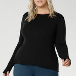 Designed for comfort and versatility, it features a flattering close-to-body fit that moves with you, thanks to its generous stretch and breathable finish. Size 18 model wears black knit top has thumbholes that can be used or tucked away for versatility in styling and extra warmth. 