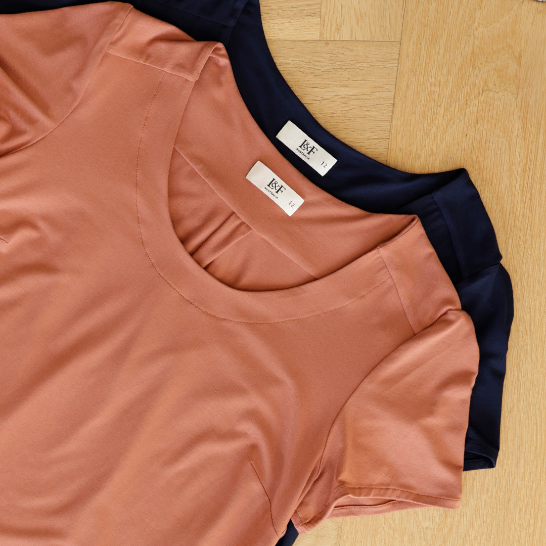 Image shows two tops for women by Australian and New Zealand women's clothing brand, Leina & Fleur. Made in breathable bamboo jersey, these lightweight summer tops are available in amber and navy blue. Shop bamboo jersey tops in plus sizes and petite sizes online at Leina & Fleur. 