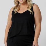 A good loungewear cami top for curve women, a size 18 woman wears a plus size cami top in black bamboo jersey. Thermo-regulating this sleepwear top is a good top for night sweats. Shop lounge wear tops online in sizes 8-24.