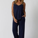 Showing good lounge pants for over 40s women, a size 12 woman wears straight, wide leg navy blue, plus size lounge pants in bamboo jersey with a blue bamboo jersey cami top. Breathable and thermo-regulating this is a good pyjama set  for night sweats and hot flushes. Stay cool for summer nights with breathable sleepwear by L&F Australia in sizes 8-24.