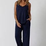 Showing good lounge pants for over 40s women, a size 12 woman wears straight, wide leg navy blue, plus size lounge pants in bamboo jersey with a blue bamboo jersey cami top. Breathable and thermo-regulating this is a good pyjama set  for night sweats and hot flushes. Stay cool for summer nights with breathable sleepwear by L&F Australia in sizes 8-24.