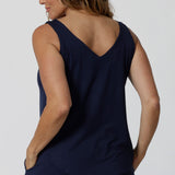 Back view of an over 40s woman wearing a size 12 cami top in navy bamboo. This V-neck cami top is worn with navy bamboo jersey lounge pants as cooling pajamas for night sweats. Shop pyjamas for menopause in sizes 8 to 24 online at L&F Australia,