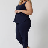 Side view of a curvy woman wearing a size 18 cami top in navy bamboo. This plus size cami top is worn with navy bamboo jersey, tapered leg lounge pants as cooling pajamas for night sweats. Shop women's plus size pyjamas for menopause in sizes 8 to 24 online at L&F 