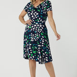 A great workwear dress for over 40 women, a size 12 woman wears the Casey dress with short sleeves, cowl neckline and knee length skirt. Made in sizes 8 to 24 by Australian and New Zealand women's fashion brand, Leina & Fleur this is also a good summer dress for plus size women, and with it's knee-length skirt, for petite women too. 