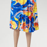With a flattering cowl neckline, blouson bodice, and softly flowing asymmetrical skirt, it’s finished with delicate shoulder tucks and a vibrant floral print. Perfect for holidays, casual weekends, or any warm summer day. Made in Australia, sizes 8–24.