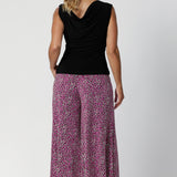 Palazzo pants feature a mid-rise cut and pull-on double-layer waistband to ensure a comfortable, secure fit while maintaining a sleek look. The side pockets are designed with visible stitch lines, adding a subtle, modern detail to the design. Over 40's model wears her palazzo pants in a size 12.