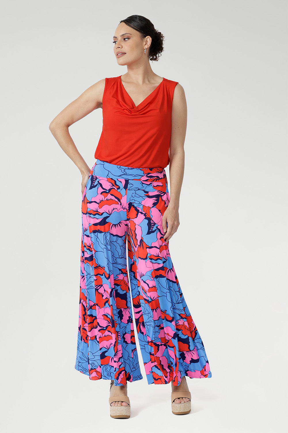 ith a wide-leg silhouette, double-layer waistband, and practical side pockets, it’s finished in a striking painterly print of blue, red, and pink. Perfect for holidays, events, or adding playful charm to everyday style.