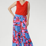 ith a wide-leg silhouette, double-layer waistband, and practical side pockets, it’s finished in a striking painterly print of blue, red, and pink. Perfect for holidays, events, or adding playful charm to everyday style.