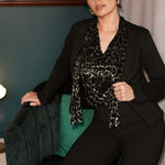 The Celine Top in Animal Burnout is a sophisticated statement piece, expertly crafted from luxurious velour fabric with a distinctive burnout effect. Designed to transition seamlessly from office wear to special events, this versatile blouse can be styled tucked in for a polished look or worn loose for effortless elegance.