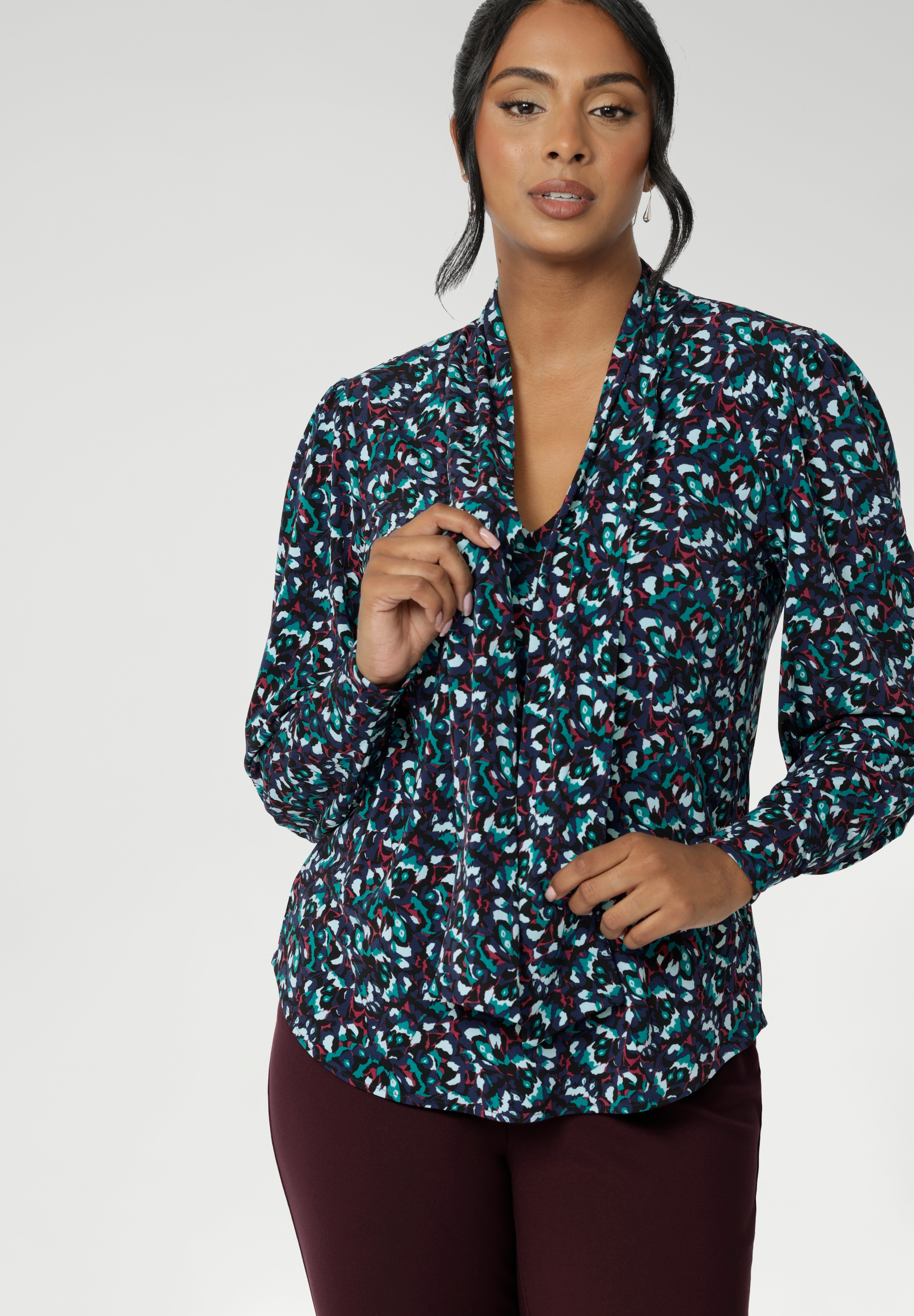 The Celine Top brings refined drama to cool-weather dressing, blending softness, structure, and statement detail in one beautifully cut piece. With its elegant V-neckline and flowing attached neck ties, this blouse offers effortless sophistication, while subtle tailored tucks at the back create a graceful shape that moves easily with the body. 