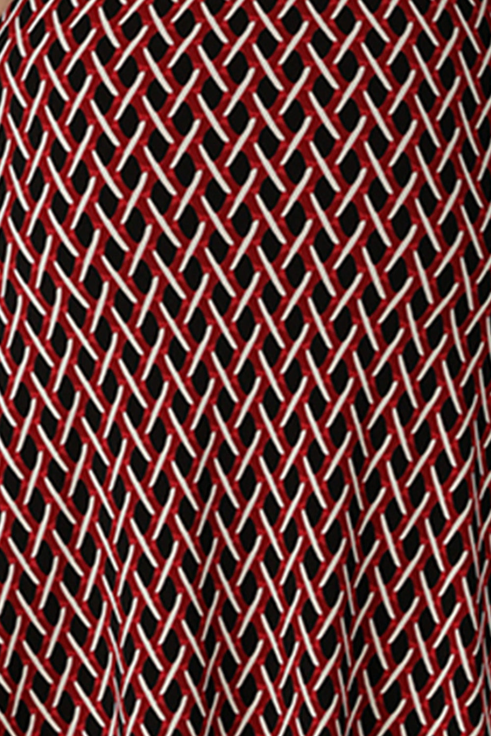 A swatch of red, vanilla and black 'Chevron' print fabric used by Australian fashion brand, Leina & Fleur to make women's work jackets, tops and pants.
