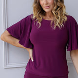 This magenta flutter-sleeved top from Leina & Fleur is the perfect blend of chic sophistication and everyday comfort. Crafted with care by the Australian brand, it's made from stretchy, dry-touch jersey fabric that feels soft against the skin while providing excellent flexibility and durability.